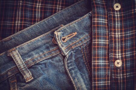 fragment of old jeans and shirt fragment of checkered fabricの写真素材