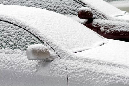 two cars, covered with snowの写真素材