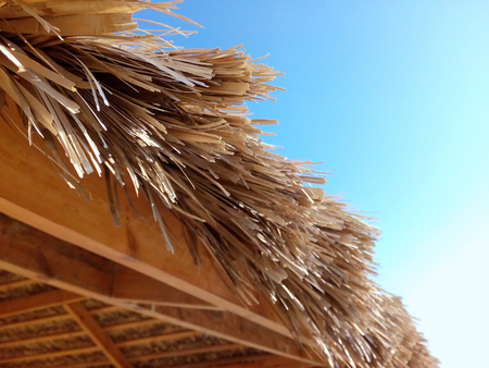 a fragment of a roof of palm leaves in the beach summer houseの写真素材