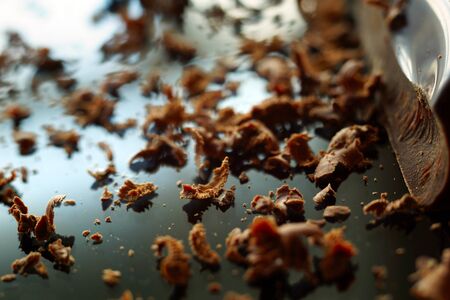 grated chocolate on the black glossy surfaceの写真素材
