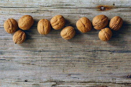 Walnuts on the background of an old board. top view