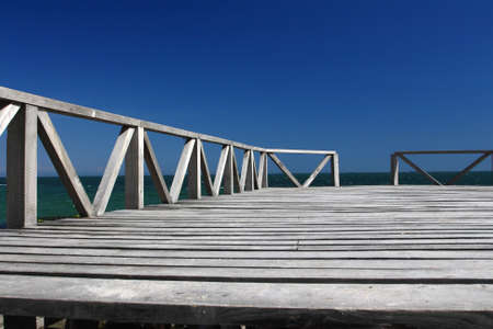 Wooden pier against the blue skyの写真素材