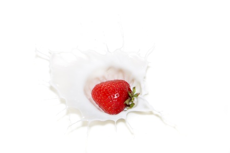 Falling a strawberry with milk splashesの写真素材