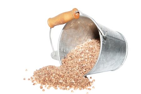 Overturned bucket with grain scattering の写真素材