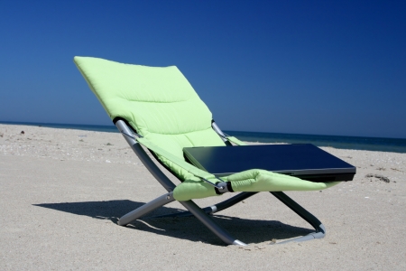 The left laptop on a chair on seacoastの写真素材