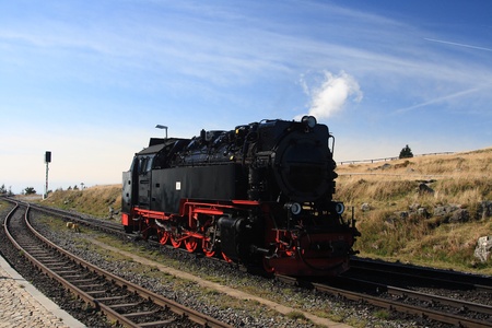 Old steam locomotive rising on mountain Brocken in Germanyの写真素材