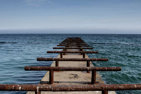 Wooden pier against the blue skyの写真素材
