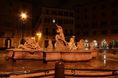 Fountain of the Neptune at night on area Navona in Romeの写真素材