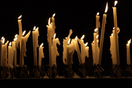Burning candles in cathedral Duomo in Milanの写真素材