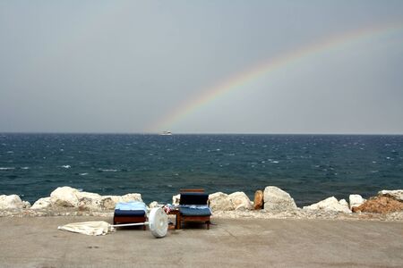 Rainbow on seacoast after a summer thunder-stormの写真素材