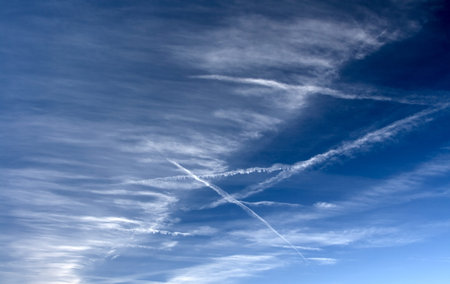 Clouds bathing in solar beams in the blue sky