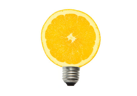 light bulb and orange in white backgroundの写真素材