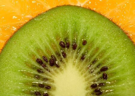 Slice of an orange and kiwi close up の写真素材