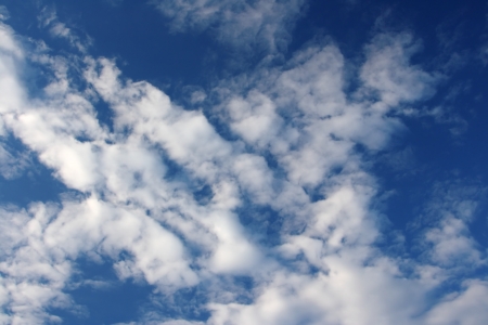 Clouds bathing in solar beams in the blue skyの写真素材