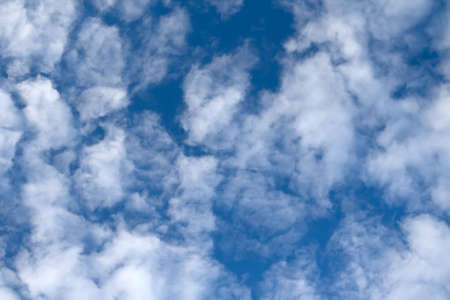 Clouds bathing in solar beams in the blue skyの写真素材