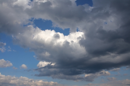 Clouds bathing in solar beams in the blue skyの写真素材