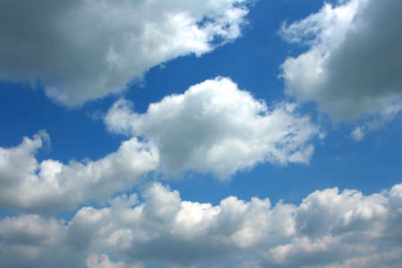 Clouds bathing in solar beams in the blue skyの写真素材