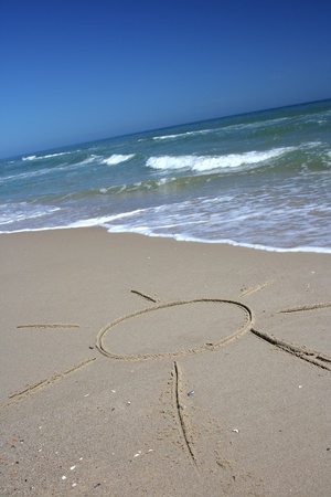 Wave about to wash the sun away.の写真素材