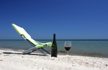 Wine glasses standing on seacoastの写真素材