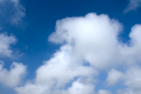 Clouds bathing in solar beams in the blue skyの写真素材