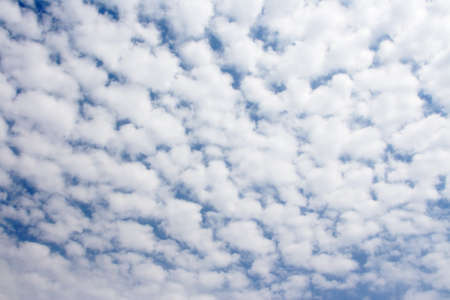 Clouds bathing in solar beams in the blue skyの写真素材