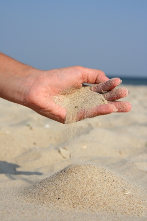 Scattered sand against the seaの写真素材