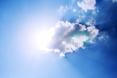 Clouds bathing in solar beams in the blue skyの写真素材