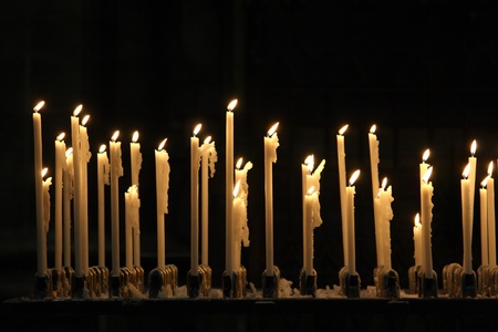 Burning candles in cathedral Duomo in Milanの写真素材