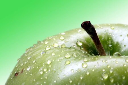 Green apple on a green background の写真素材