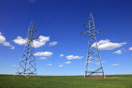 hight voltage line on the blue sky and green grassの写真素材