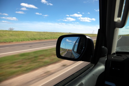 Reflexion in a mirror of high-speed movement of carsの写真素材