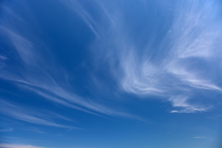 Clouds bathing in solar beams in the blue skyの写真素材