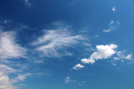 Clouds bathing in solar beams in the blue skyの写真素材