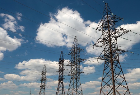 hight voltage line on the blue sky and green grassの写真素材