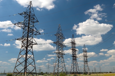 hight voltage line on the blue sky and green grassの写真素材