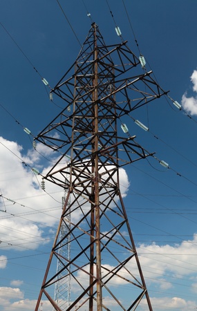 hight voltage line on the blue sky and green grassの写真素材