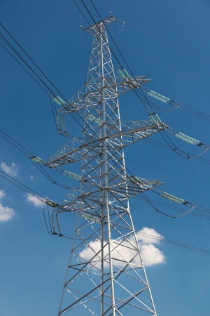 hight voltage line on the blue sky and green grassの写真素材