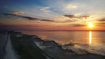 Sunset on spit between the sea and the estuary in the national park "Tuzlovsky Limany", Odessa region, Ukraineの写真素材