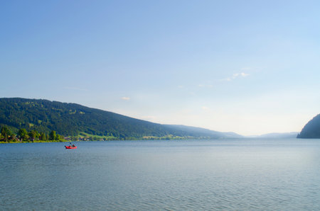 Lake is one of the most beautiful lakes in Switzerland. Red boat on the water.の写真素材