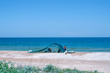 Camping tent on the beach of the sea with blue sky backgroundの写真素材