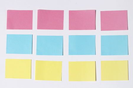 Mock-up of many empty multicolored office stickers on a wooden background. Copy space, space for text. Office conceptの写真素材