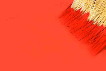 A Paint brush on surface of the trend color Living coral background, copy space