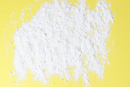 A scattered flour on a yellow background top view, copy spaceの写真素材