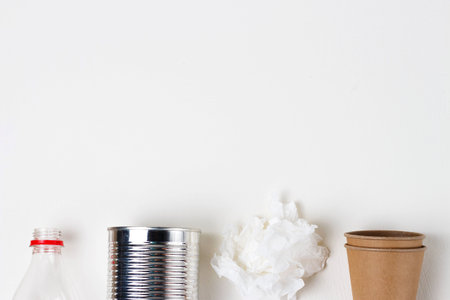 A Cardboard and plastic, iron garbage on white background, top view.