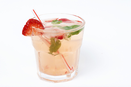 A Cold summer drink with ice and strawberries on a white backgroundの写真素材