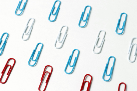 A multicolored paper clips on a white background, office conceptの写真素材