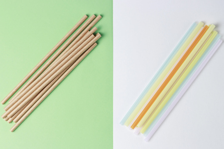 A bamboo and plastic straws for drinking on a colorful background, concept alternativeの写真素材