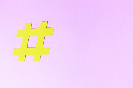 Hashtag sign isolated on pink background, close up, copy spaceの写真素材
