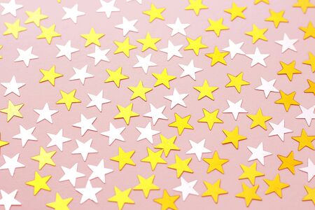 A golden stars of confetti on a whiteの写真素材