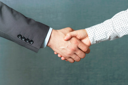 Handshake of man and woman in business clothes